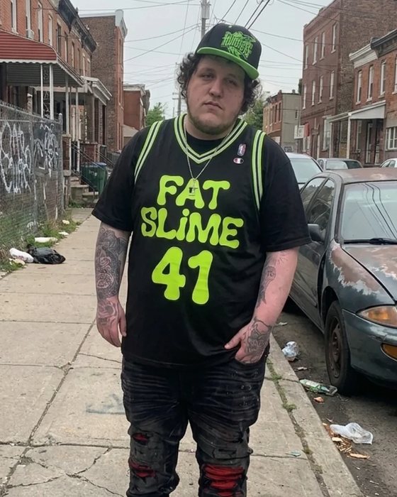 fat slime on the sidewalk wearing the black and slime green #41 jersey